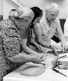 Mennonite Women Prepare Fresh Bread at the MCC Relief Auction in Saskatoon, 1985 (11 Kb): photo by Allan Siebert