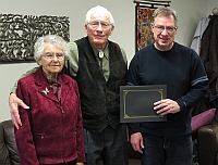 (Left to Right): Erna and Henry Goerzen and MHSC President Richard Thiessen presenting the 2018 Award of Excellence